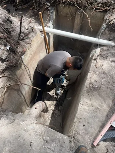 Hometown Hero's Plumbing technician excavating to reach a damaged pipe