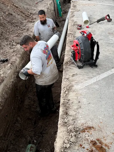Hometown Hero's Plumbing crew installing new pipe in a trench